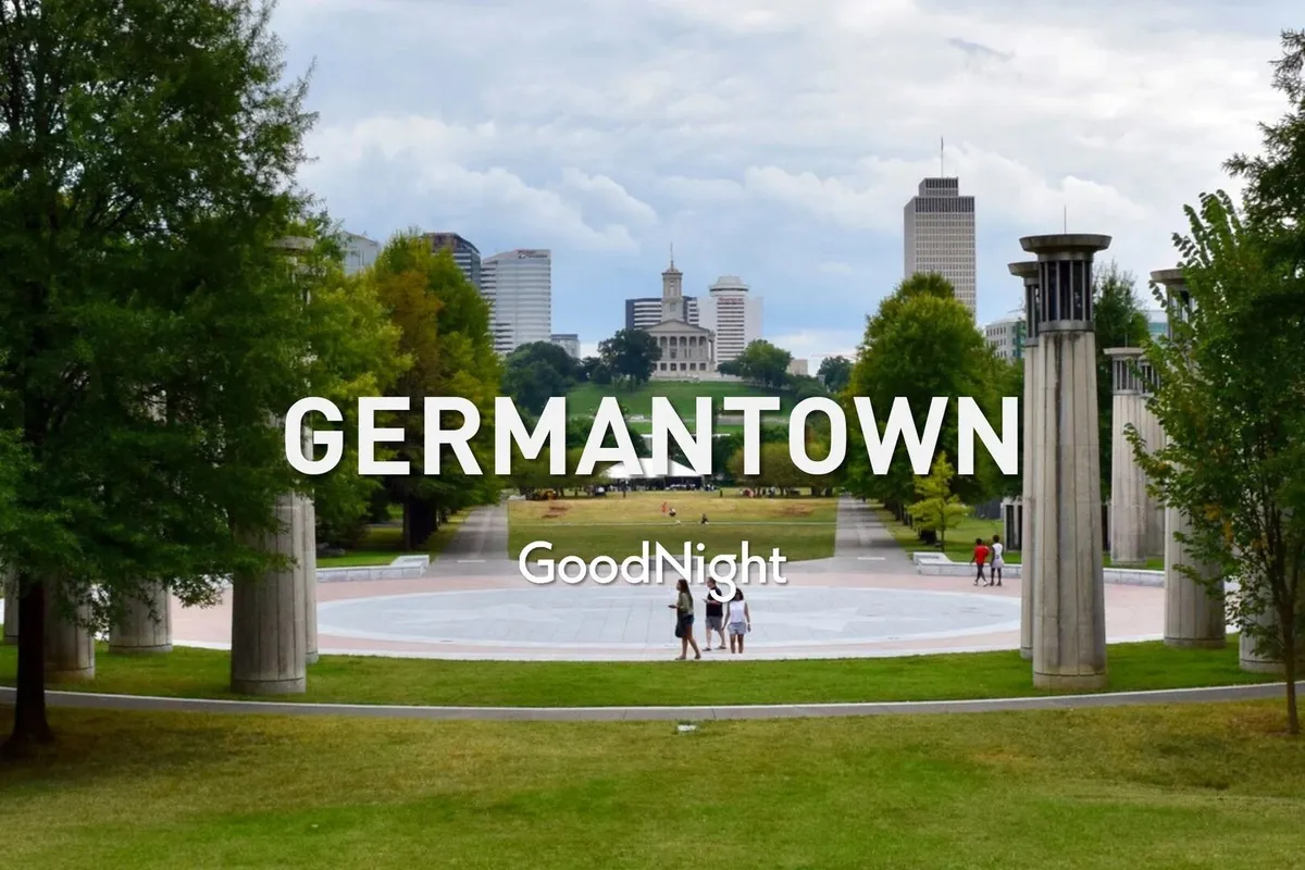 A peaceful park scene with a city skyline in the background, walking paths, and people enjoying the outdoors. The view combines urban convenience with moments for relaxation in a community setting.